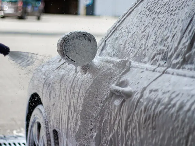 SNOW FOAM white active foam on a car at a BKF car wash