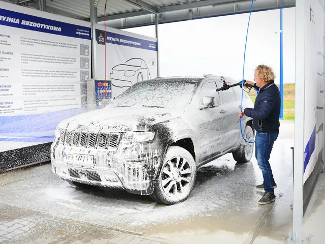 Car being washed at a self-service touchless car wash bay